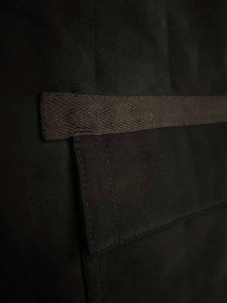 Close-up of a black fabric with a strap on a dark background