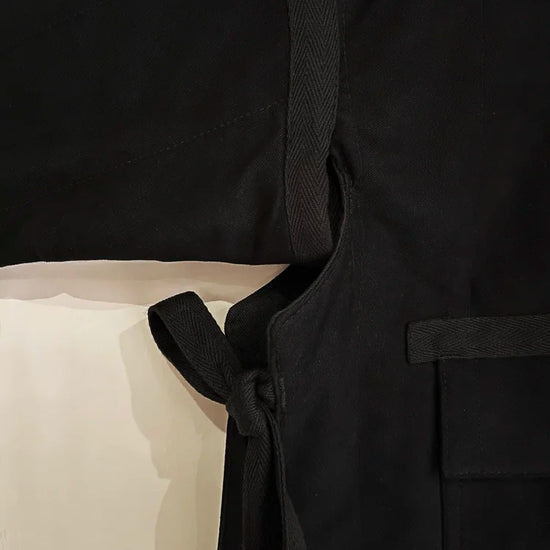 Black robe with a belt on a neutral background