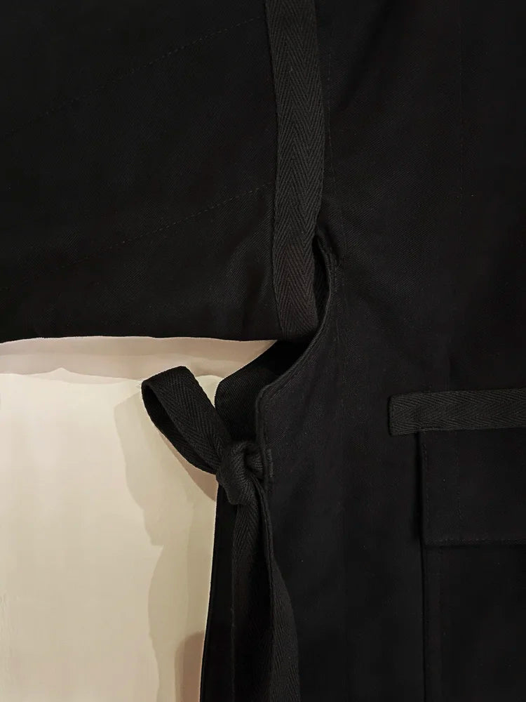 Black robe with a belt on a neutral background