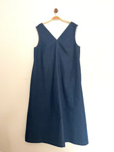 Load image into Gallery viewer, Indigo denim aline sleeveless long dress with a v-neck and centre seam on a cream background
