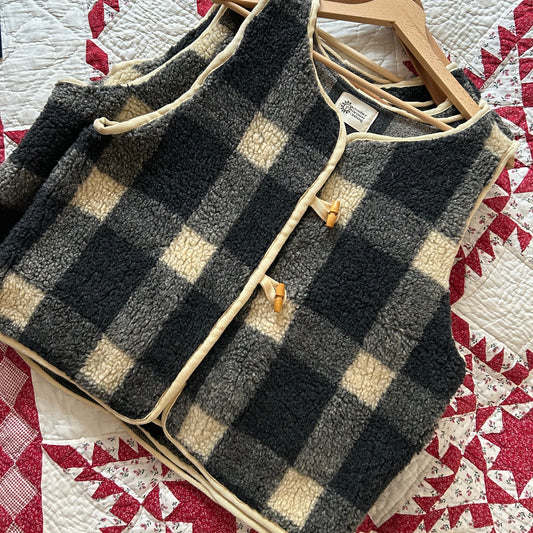 Black and beige checkered fabric on a red and white quilted surface