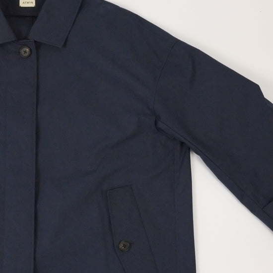 Navy blue suit jacket on a light gray background