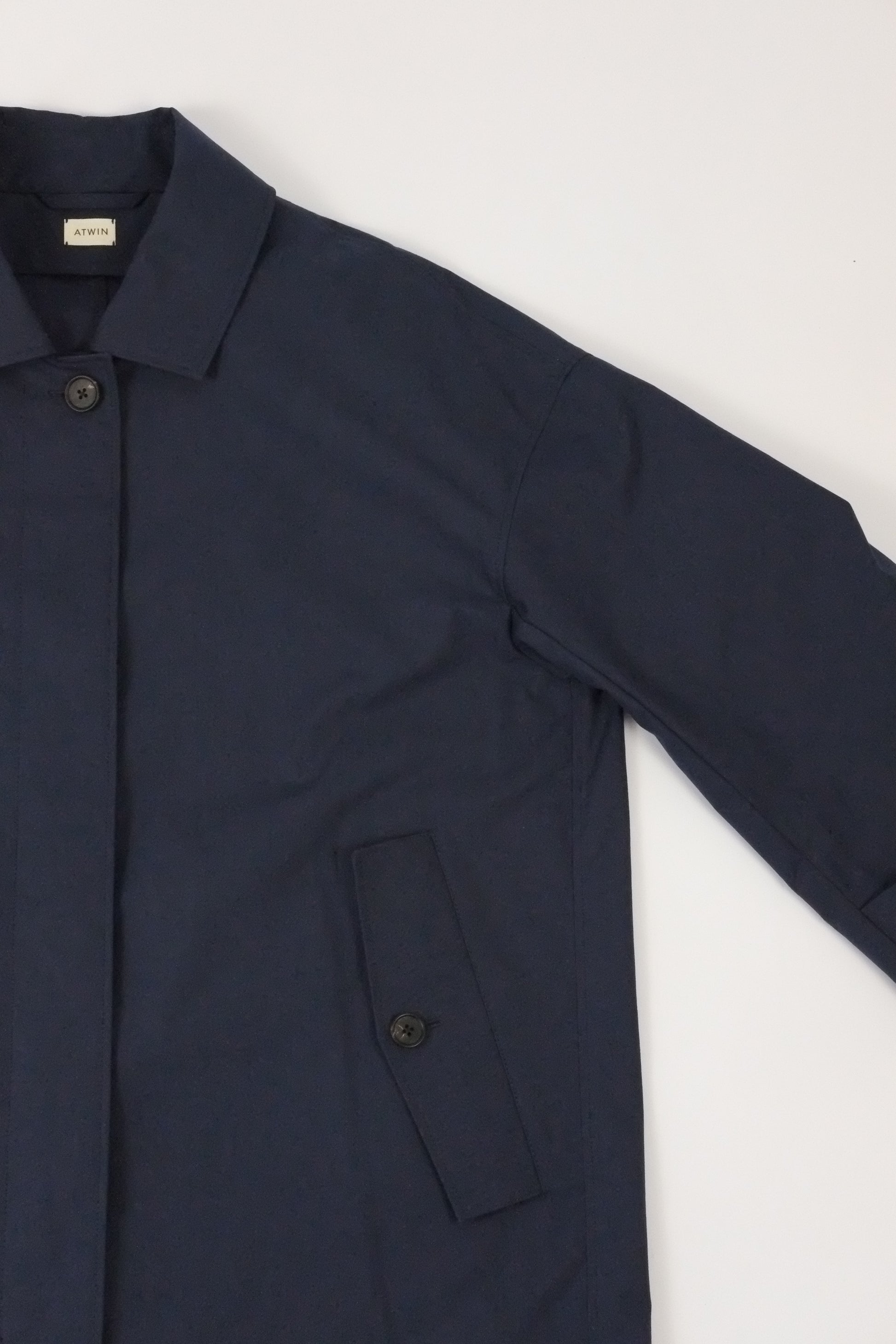 Navy blue suit jacket on a light gray background