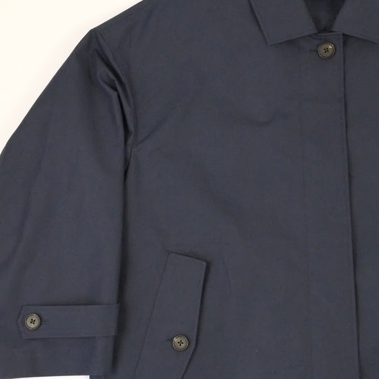 Navy blue jacket with rolled-up sleeves on a white background