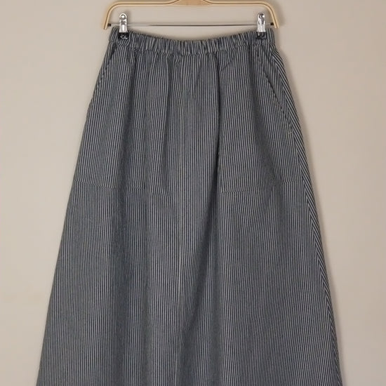 Gray pleated skirt on a beige background