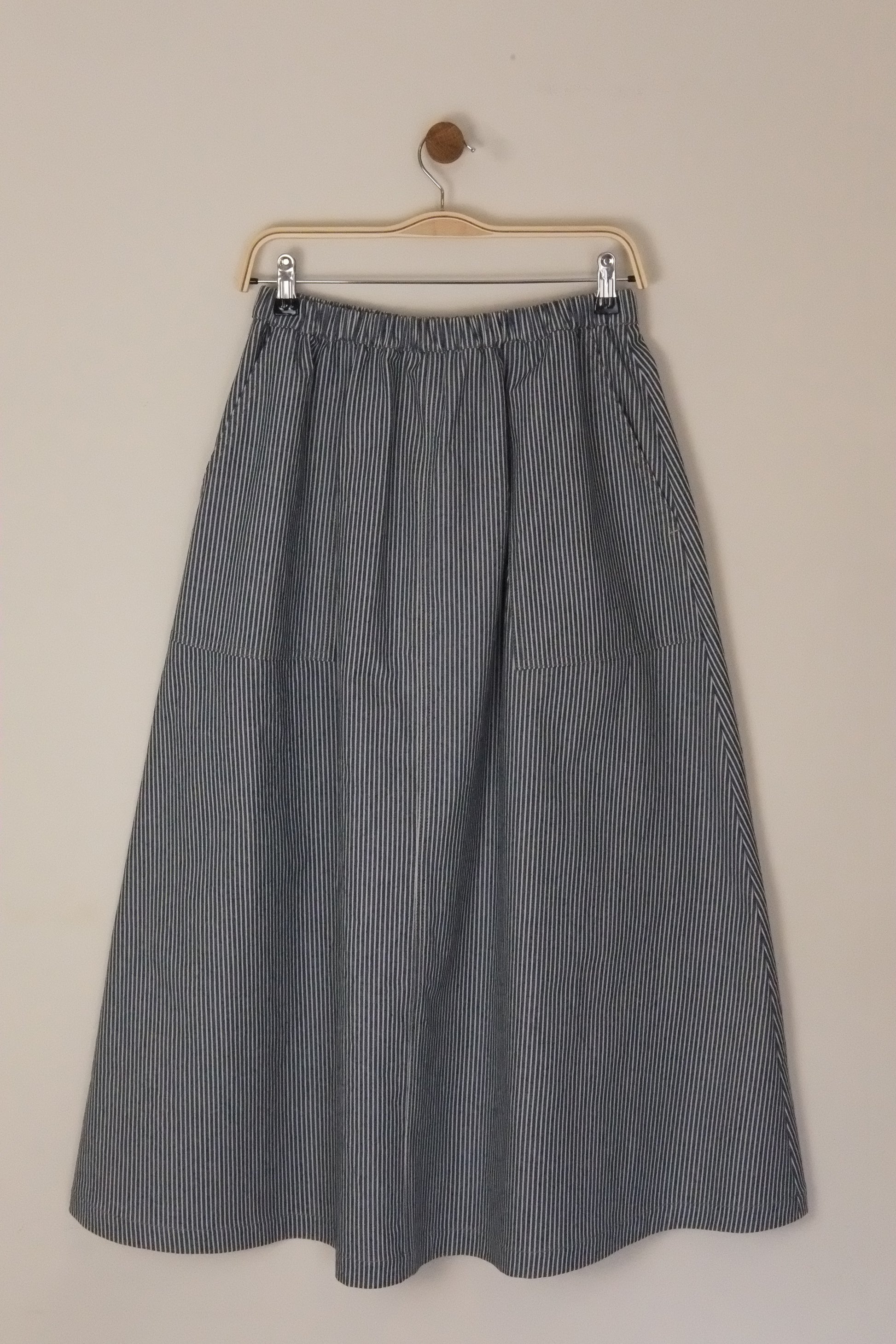 Gray pleated skirt on a beige background