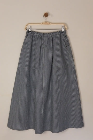 Gray pleated skirt on a beige background
