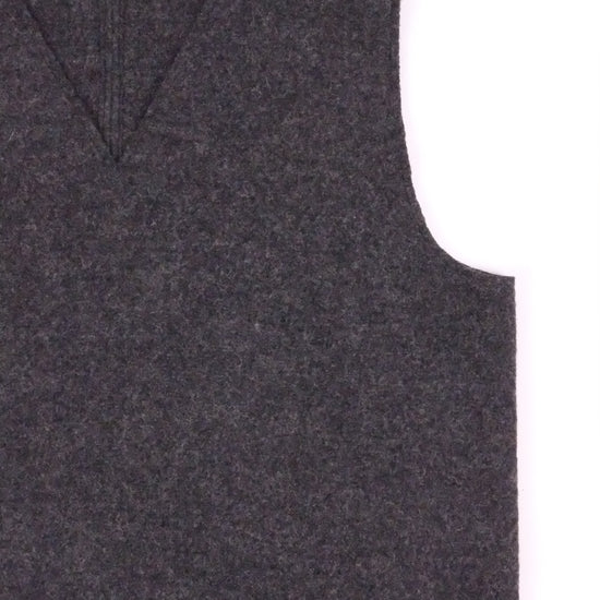 Dark gray vest with a brand label on a white background
