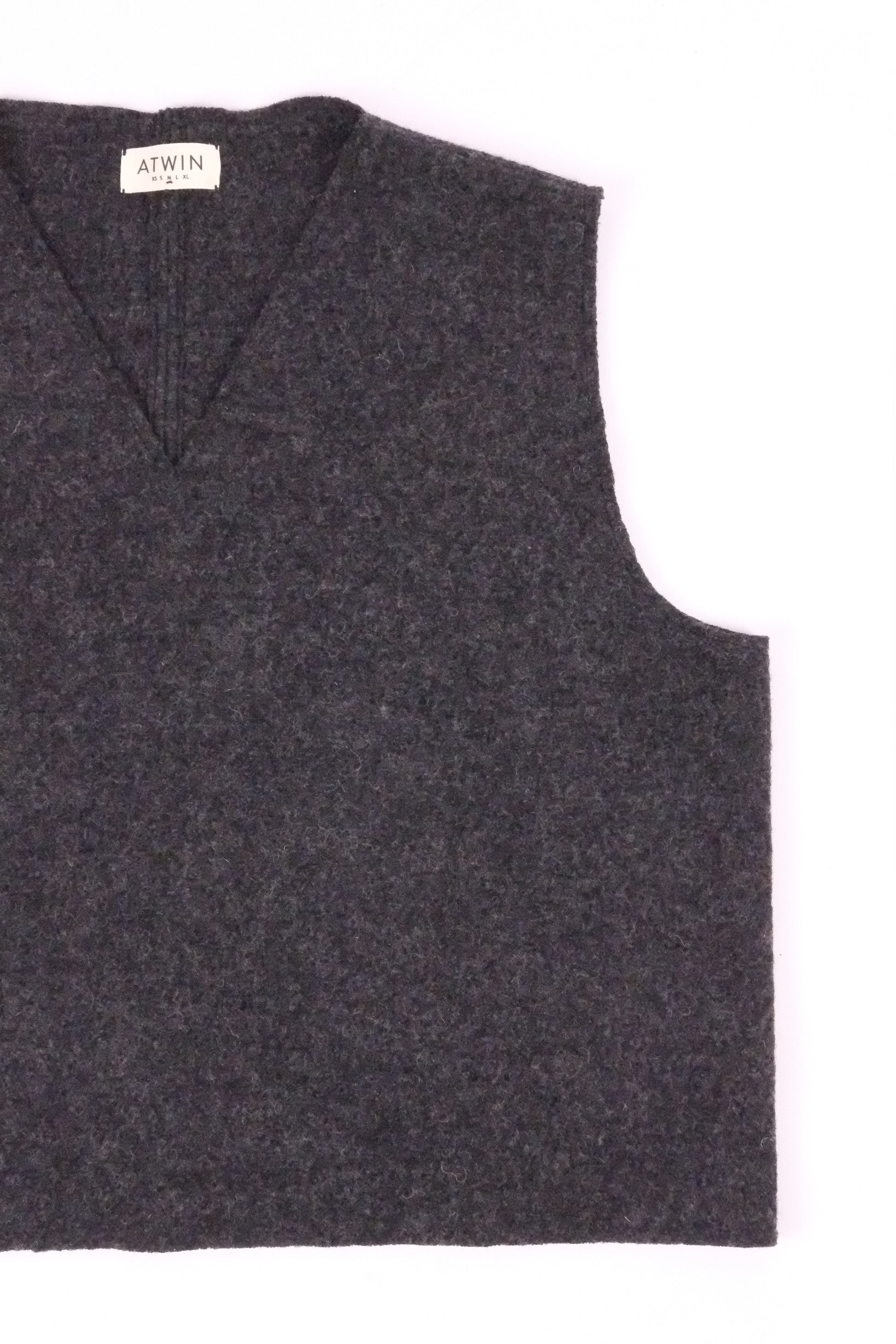 Dark gray vest with a brand label on a white background