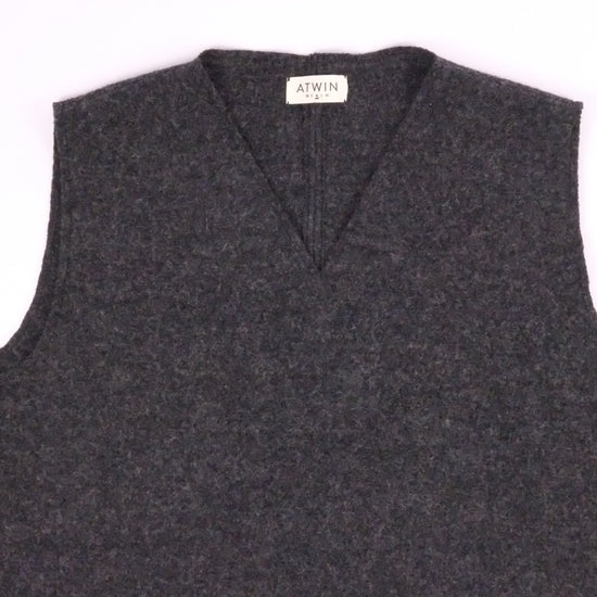 Gray sweater vest with a brand label on a white background