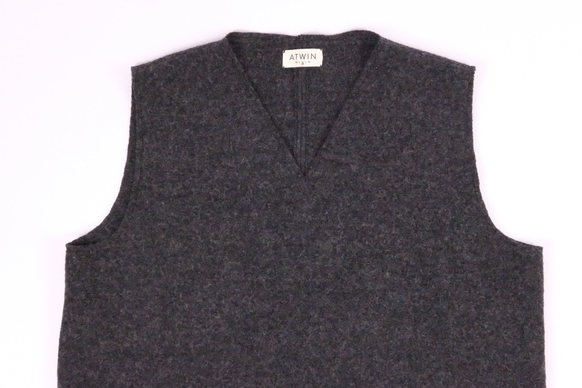 Gray sweater vest with a brand label on a white background