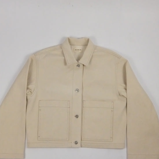 beige denim jacket on a white background 