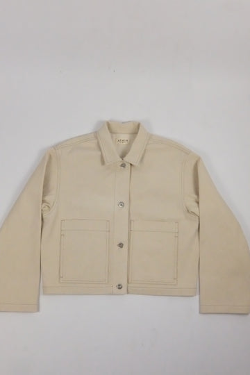 beige denim jacket on a white background 