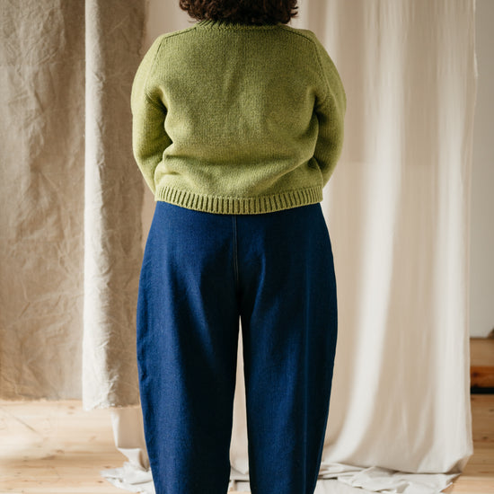 Model wearing barrel leg denim trousers – full back view