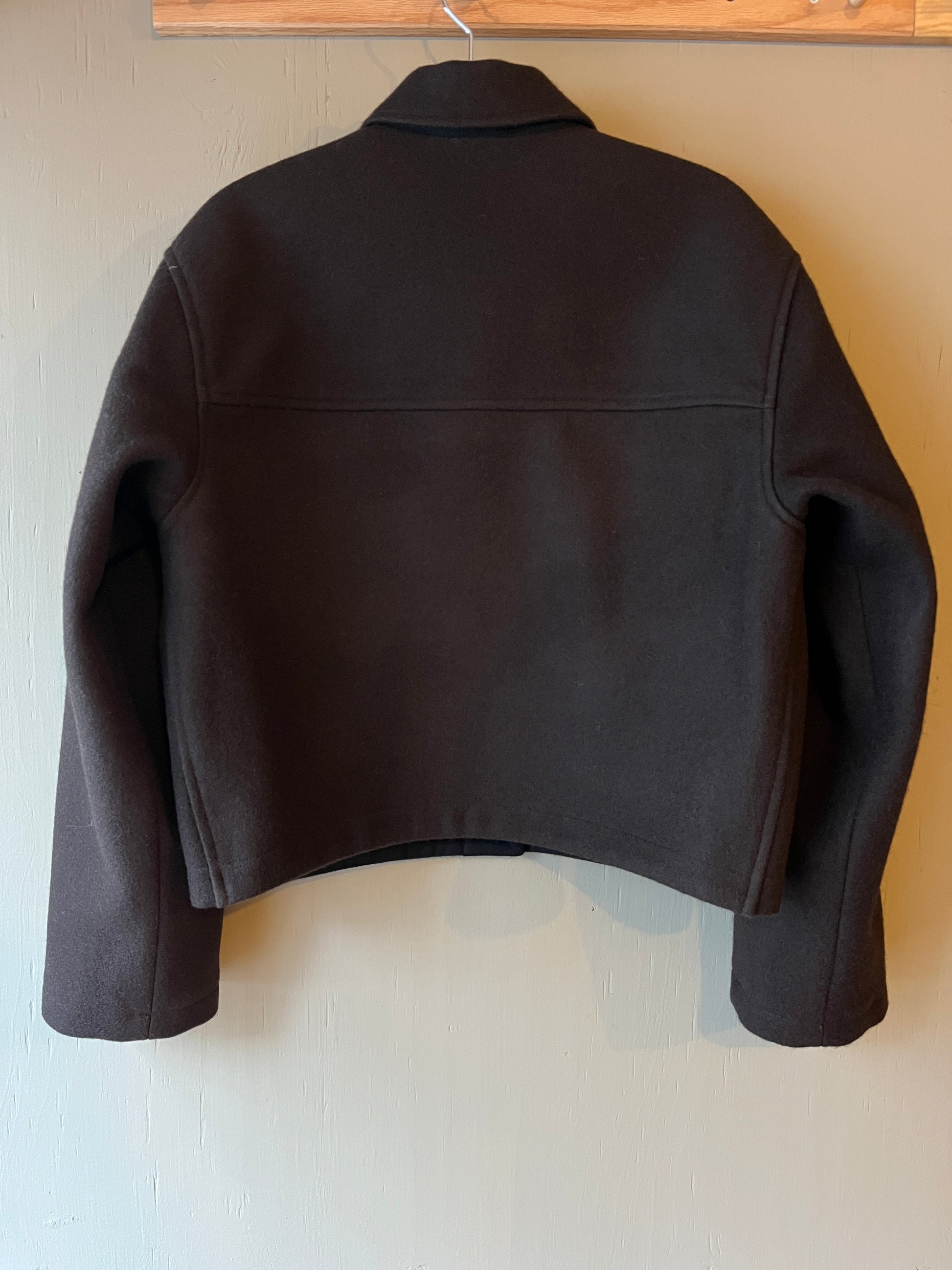 Dark brown wool cropped jacket with collar back view on a light grey background