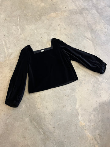 Black velvet top on a grey concrete surface