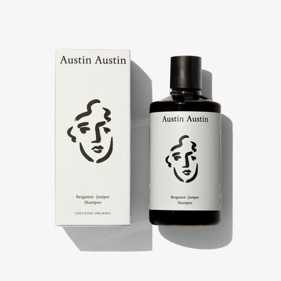 A bottle of shampoo with a face illustration on a white background 