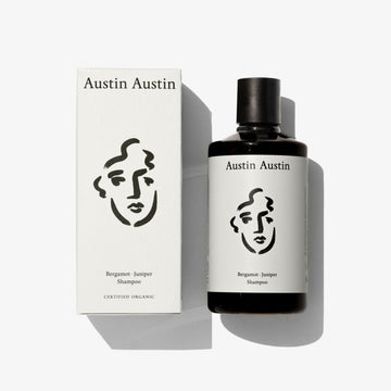 A bottle of shampoo with a face illustration on a white background 