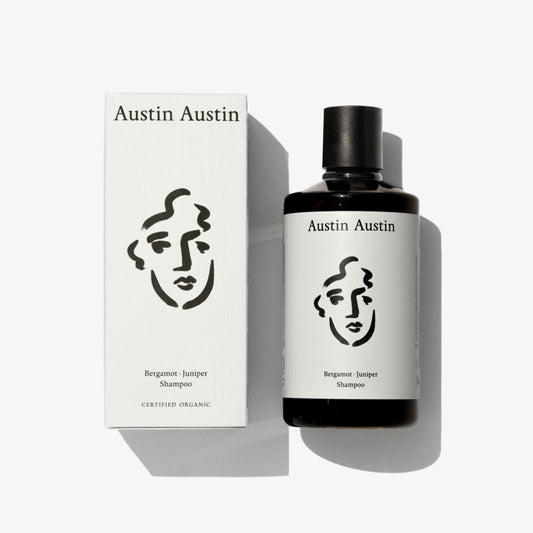 A bottle of shampoo with a face illustration on a white background 