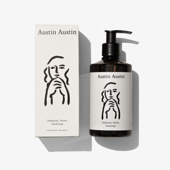 A bottle of hand cream with a face illustrated onto a white background 