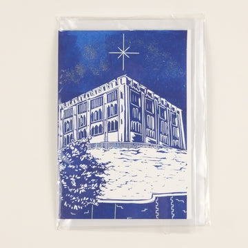 Blue and white card with a building design on a beige background