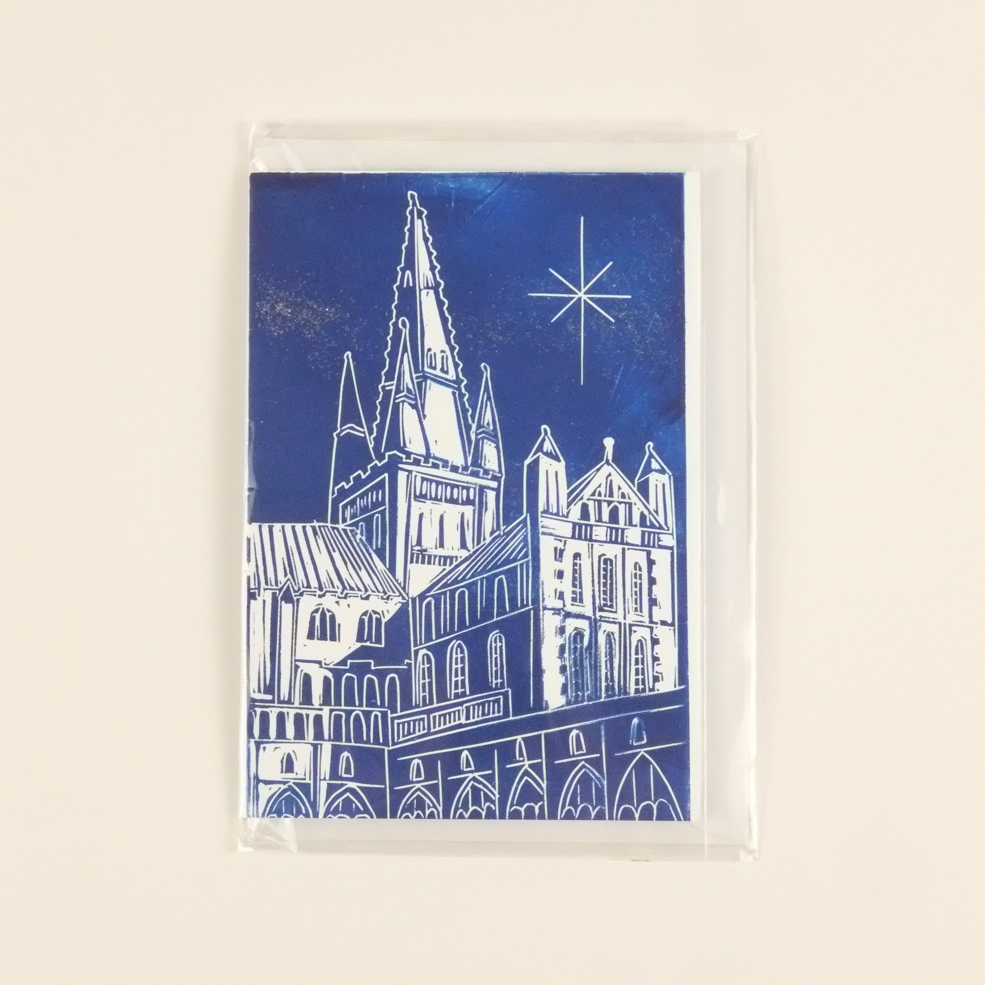 Rectangular blue card with white architectural design on a beige background