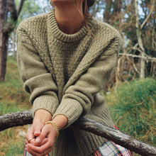 Load image into Gallery viewer, Woman wearing a green jumper in a forest setting
