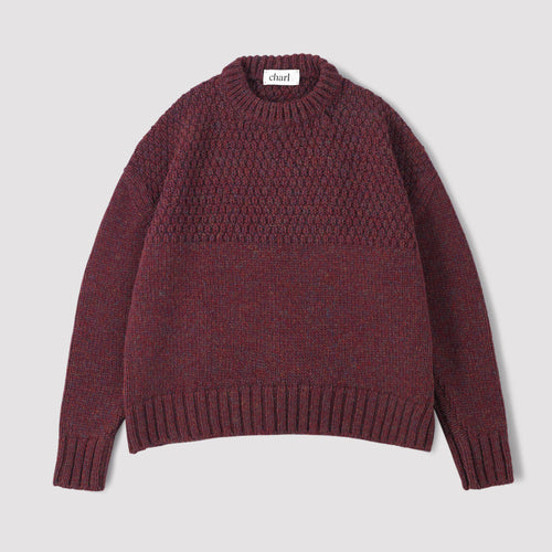 Plum coloured jumper on a white background 