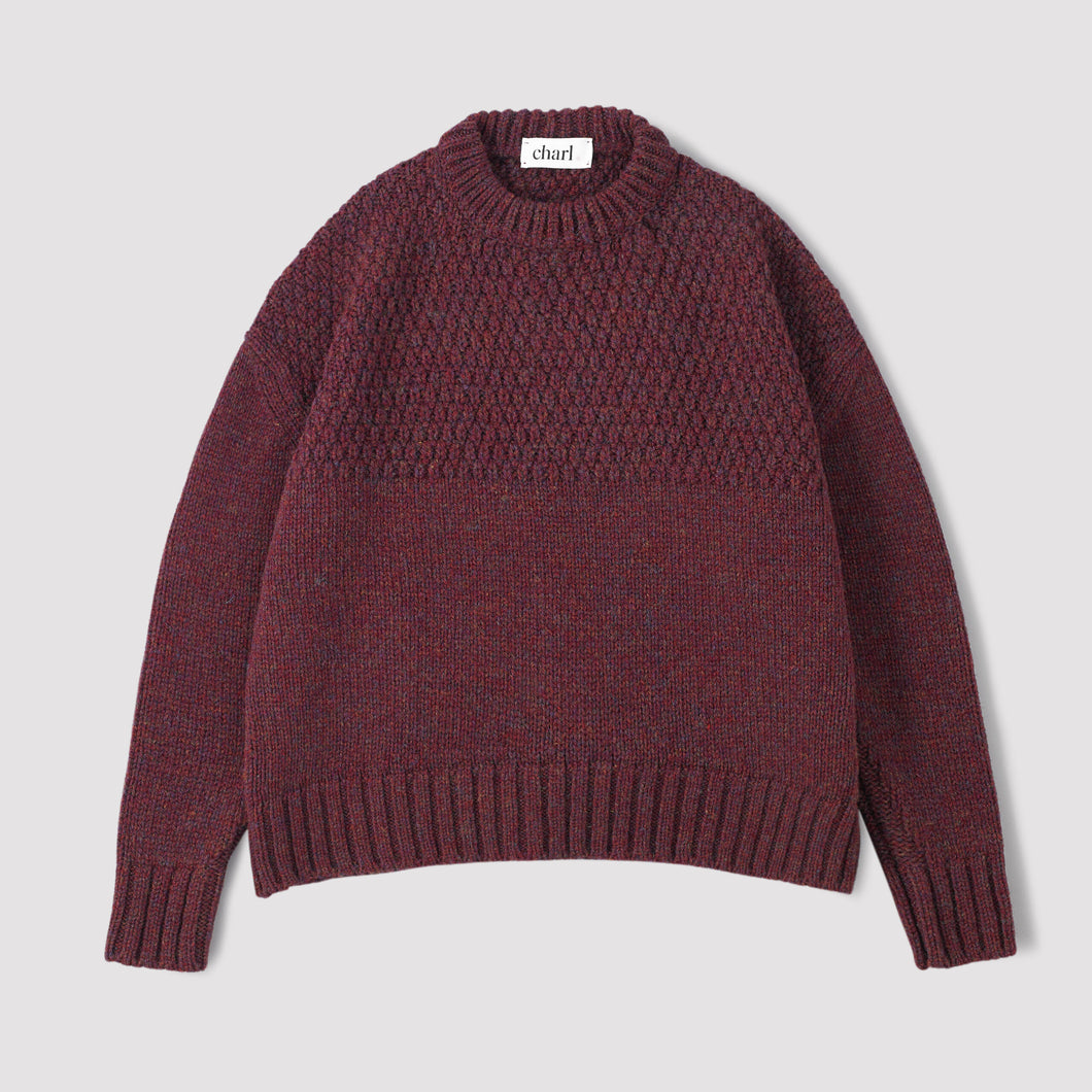 Plum coloured jumper on a white background 