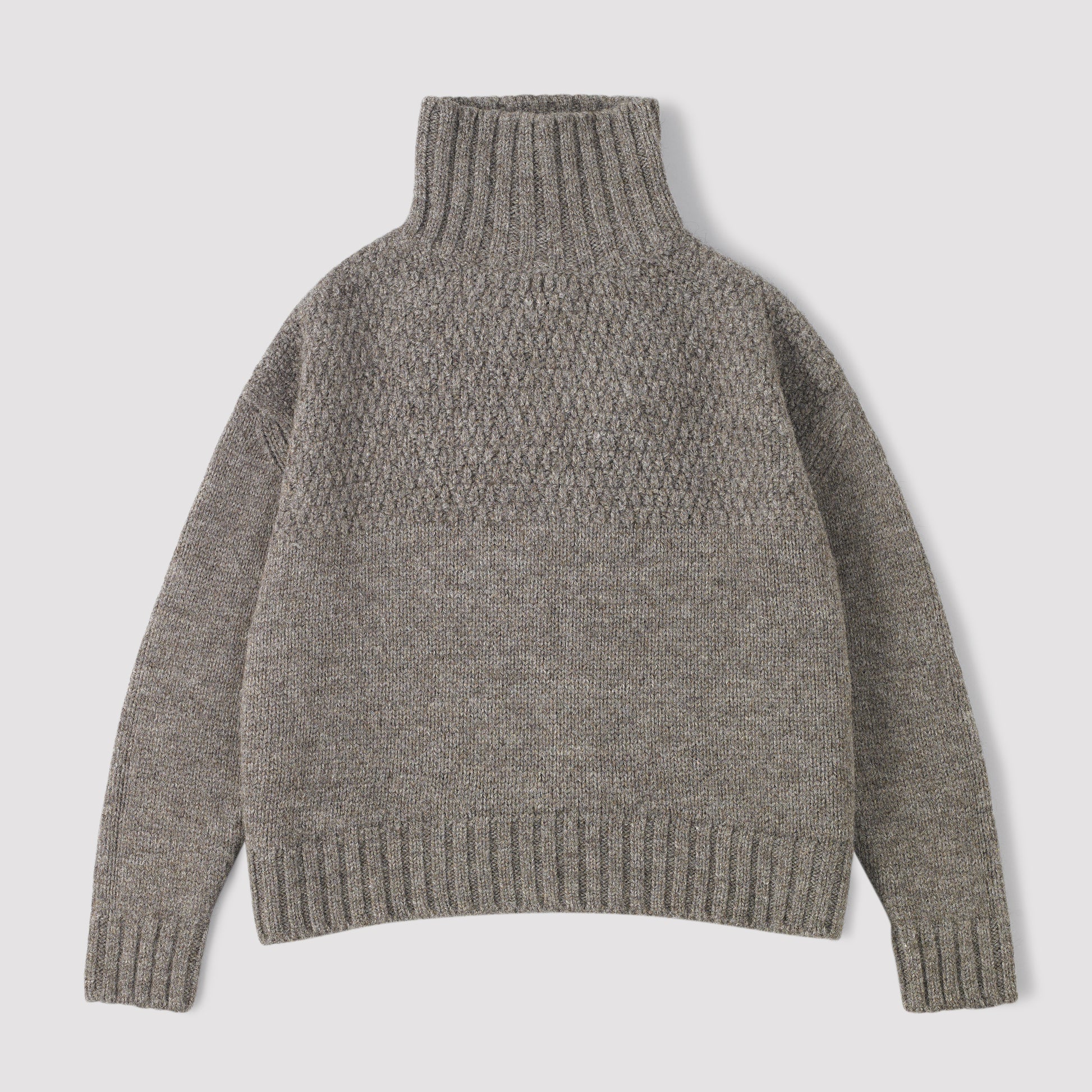 Grey funnel neck knitted sweater on a light grey background