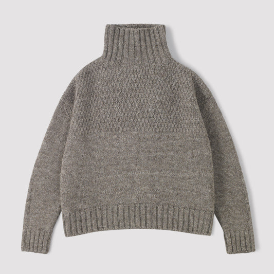 Grey funnel neck knitted sweater on a light grey background