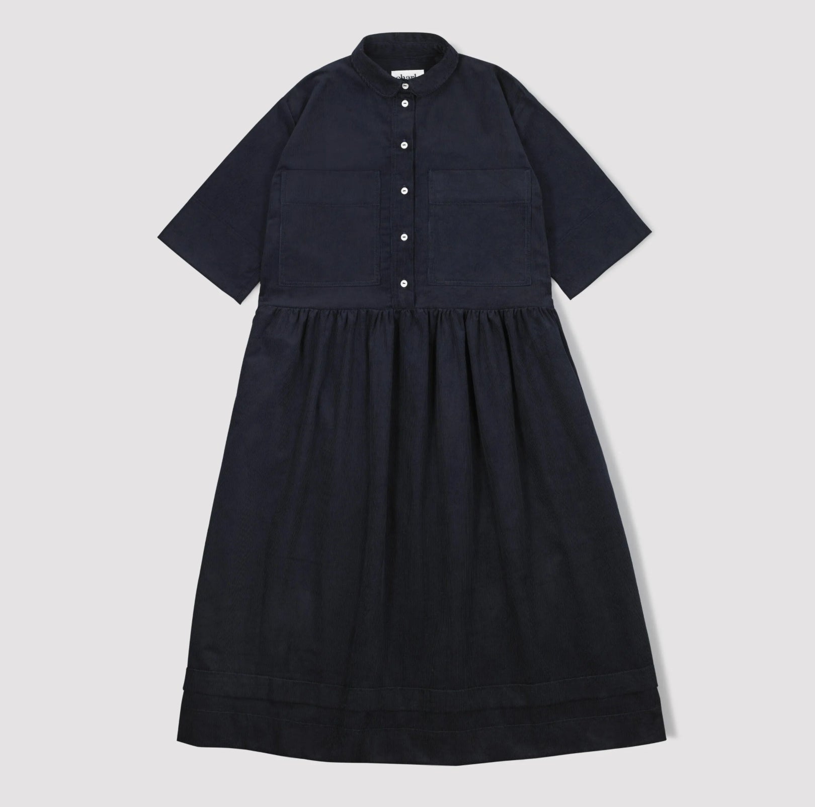 Navy corduroy dress with short sleeves and a button down front with a collar and gathered waist  on a light gray background