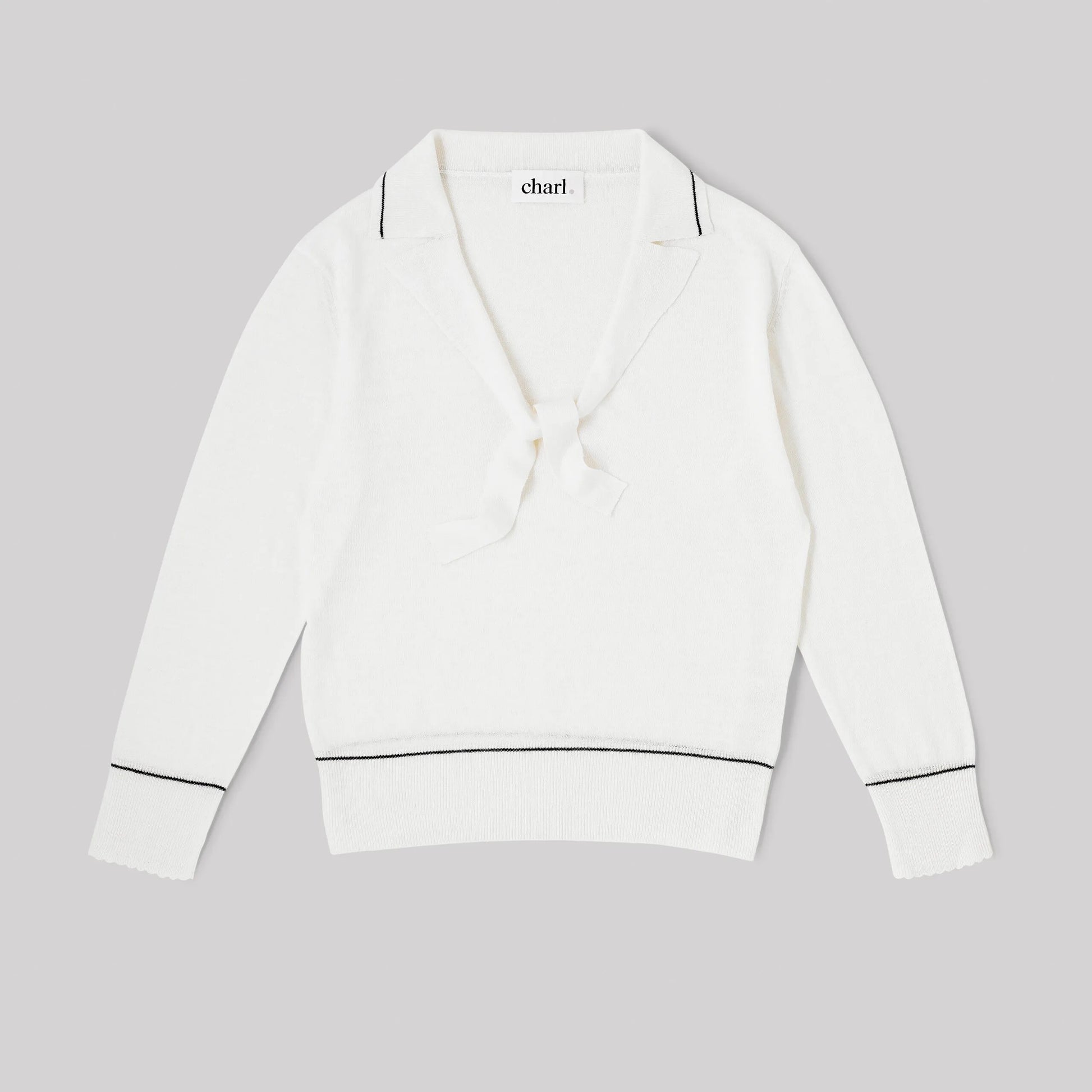 White top with blue trim on a gray background