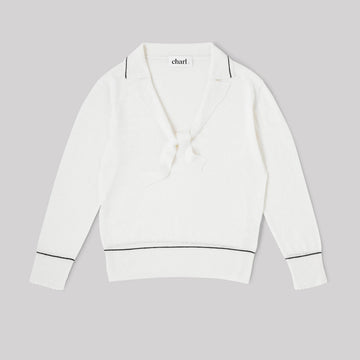 White top with blue trim on a gray background