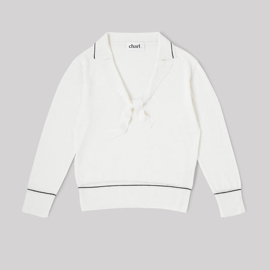 White top with blue trim on a gray background