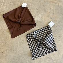 Load image into Gallery viewer, Brown and black and white checkered neck tie scarves on a concrete surface
