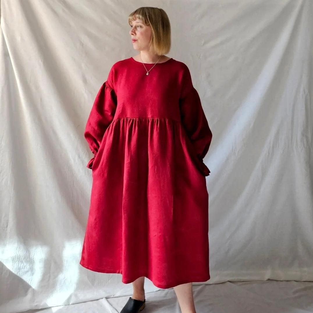 Woman wearing a red dress against a plain white background