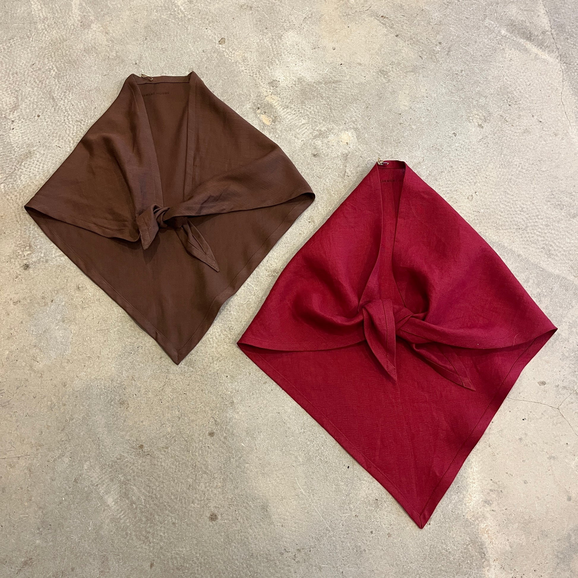 Brown and red neckerchief scarves on a concrete background