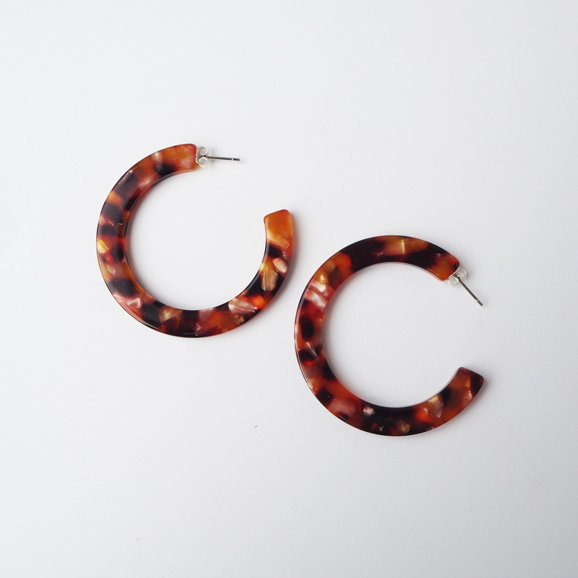 Tortoiseshell hoop earrings on a white background