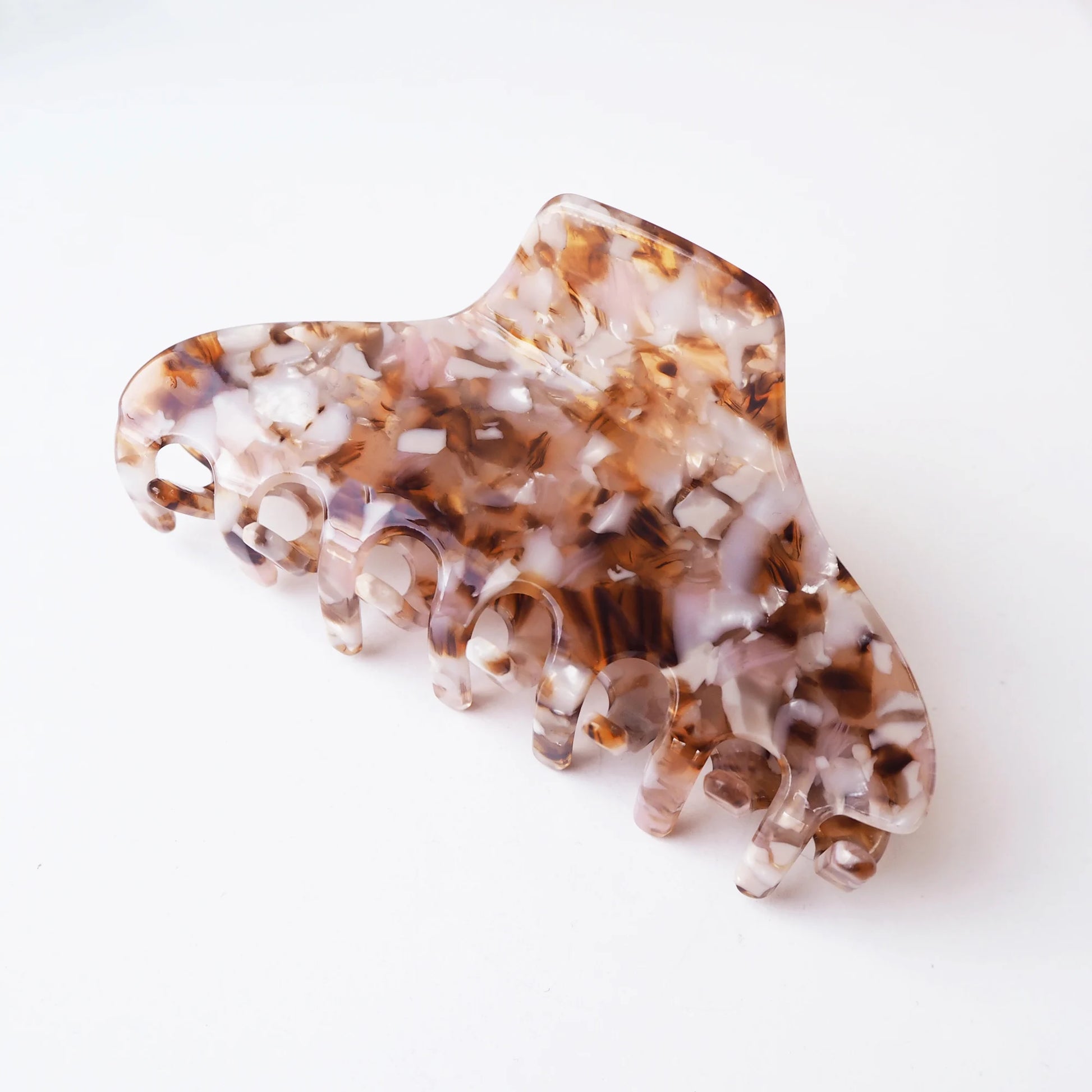 Tortoiseshell patterned hair claw on a white background