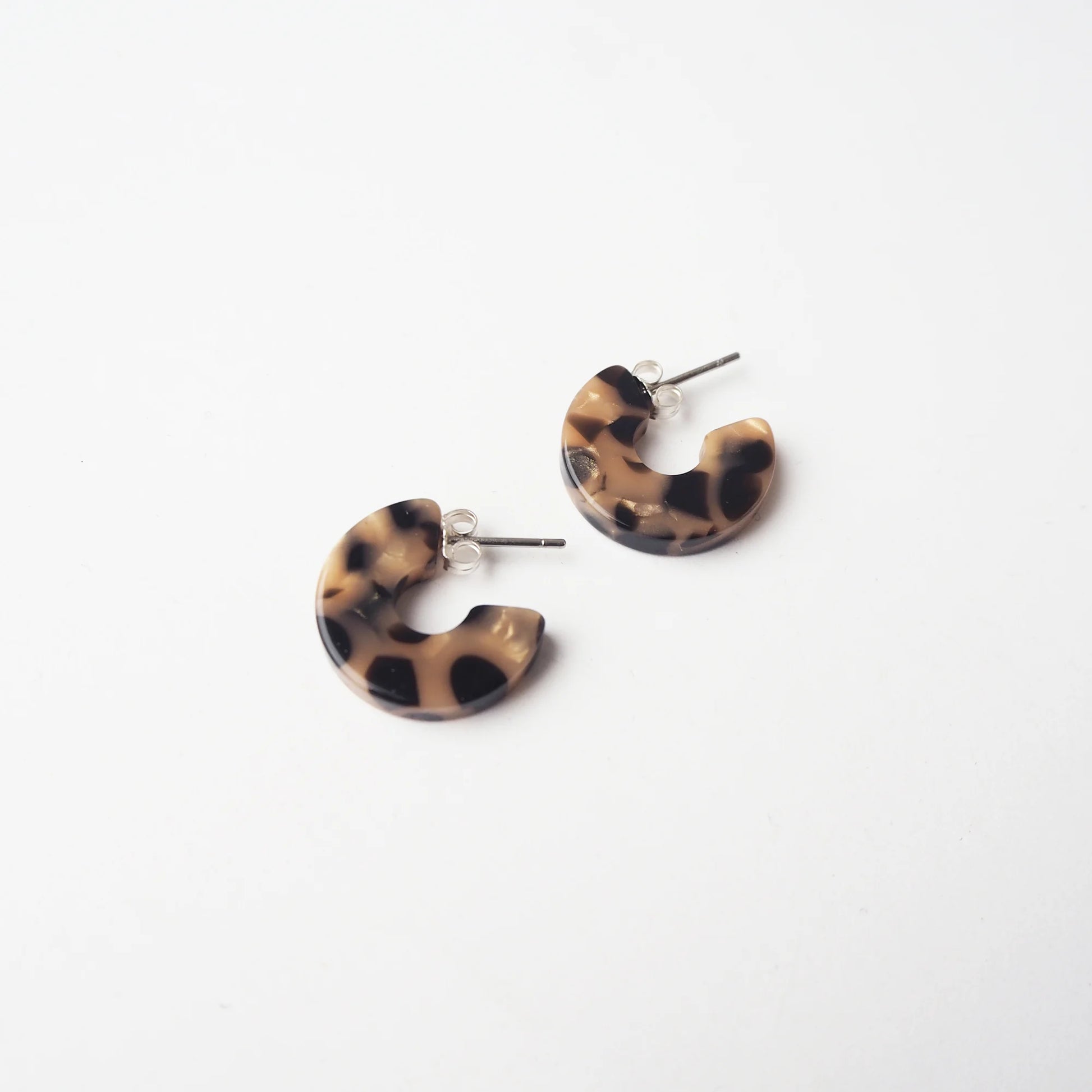 Tortoiseshell print hoop earrings on a white background