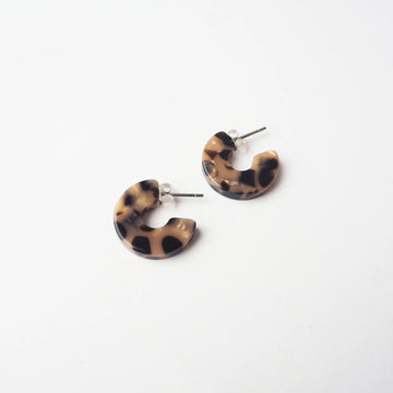 Tortoiseshell print hoop earrings on a white background