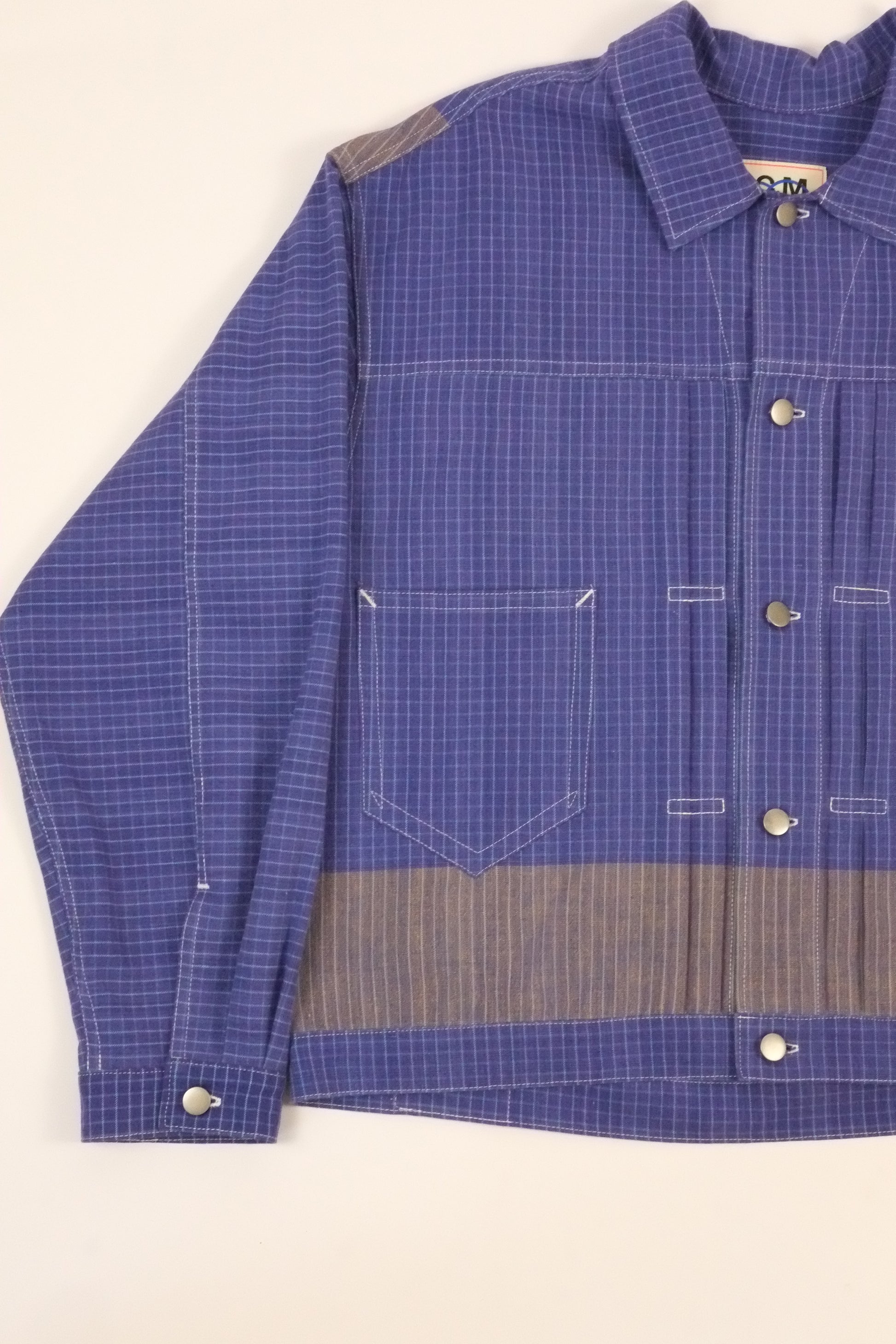 Blue checkered shirt with gray interior on a white background