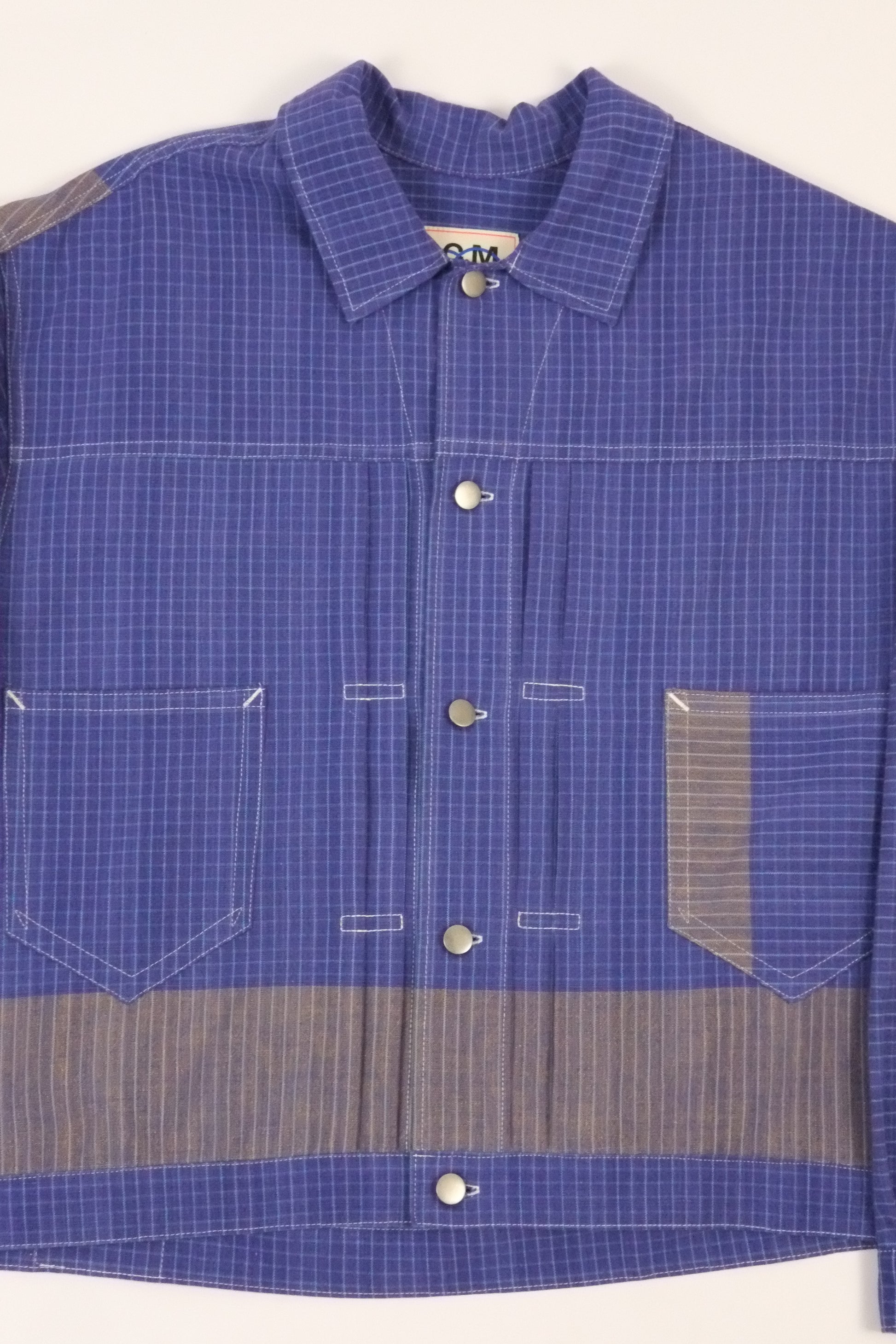 Blue checkered shirt with gray accents on a white background