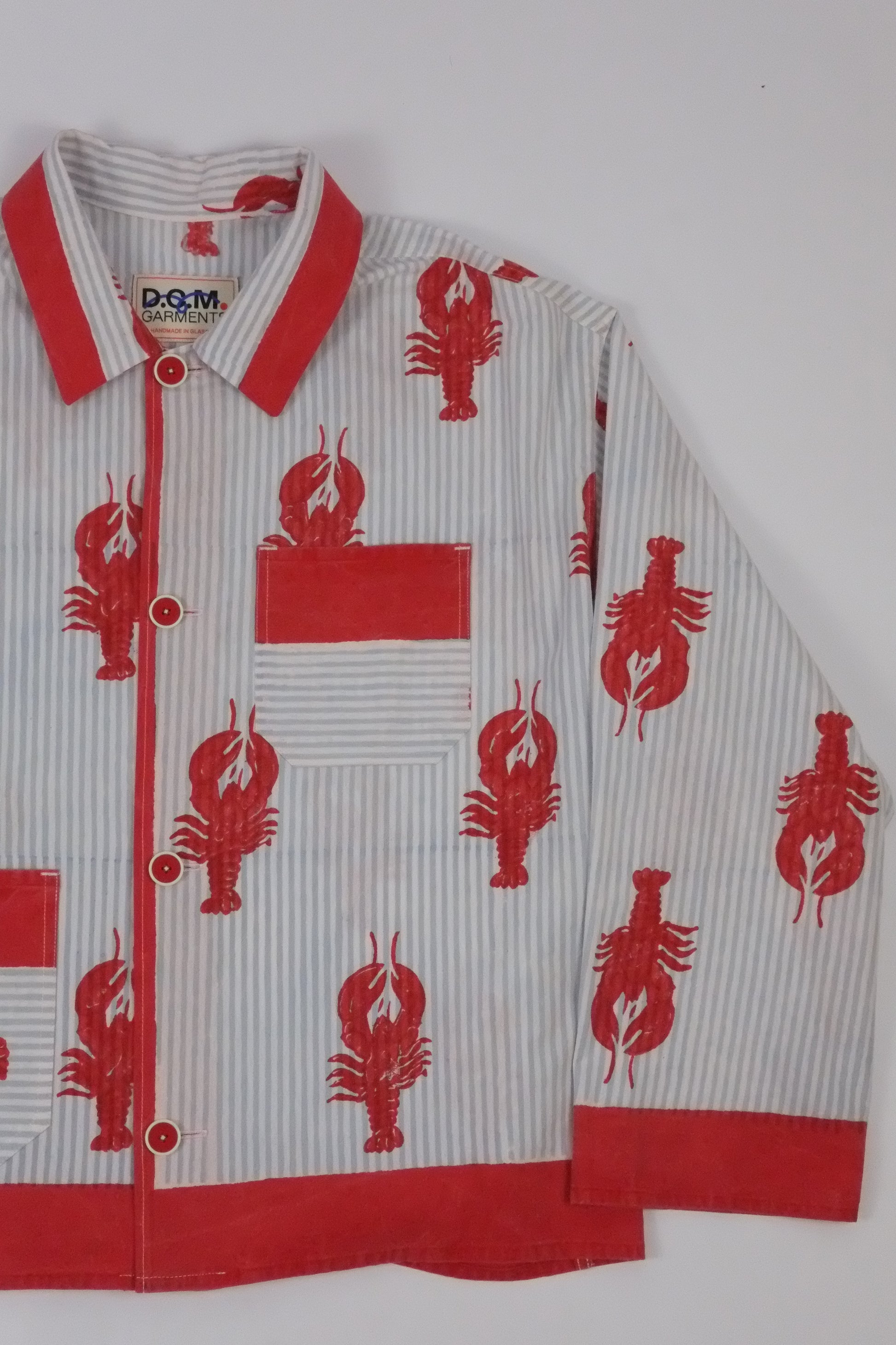Red and white sports jersey with lobster patterns on a white background