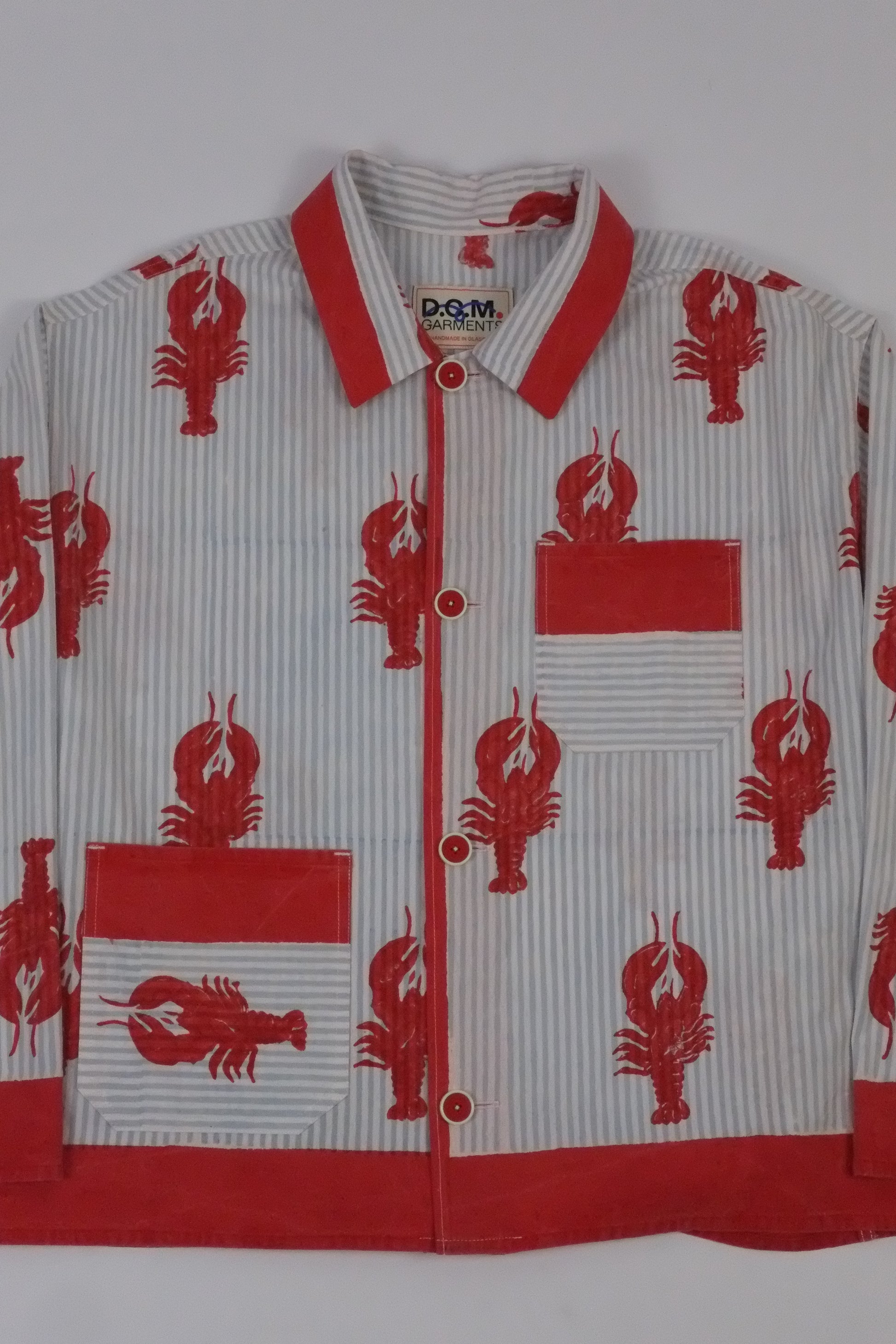 Red and white shirt with lobster pattern on a white background
