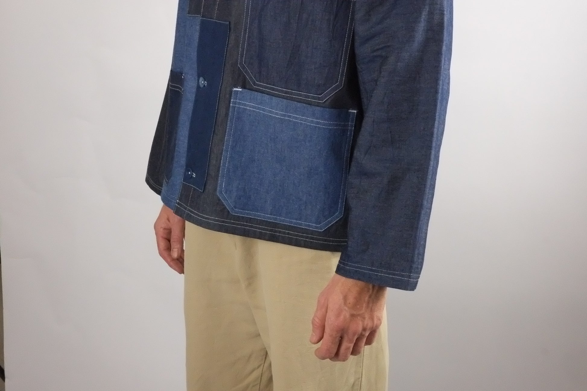 a patchwork denim jacket on a white background 