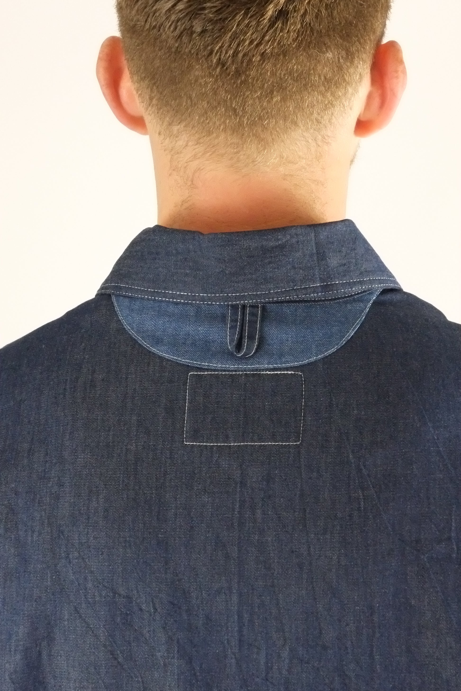 a patchwork denim jacket on a white background 