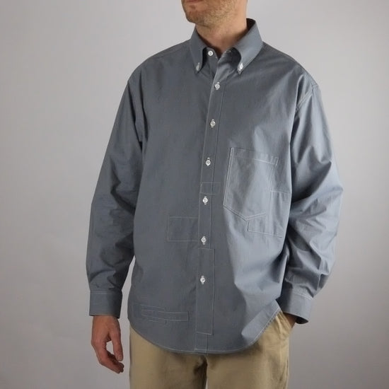 a patchwork striped shirt worn on a white background