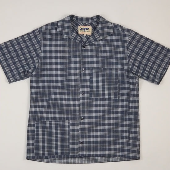 Blue and white checkered shirt on a light gray background